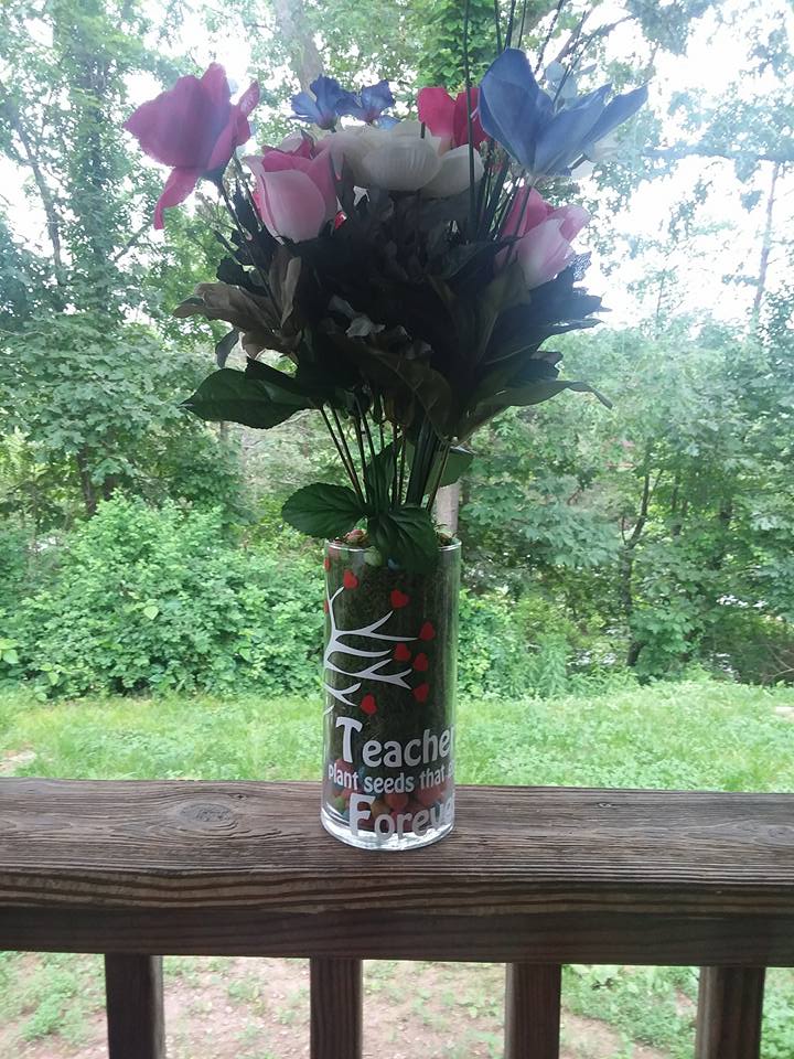 A decal on a vase with flowers in it